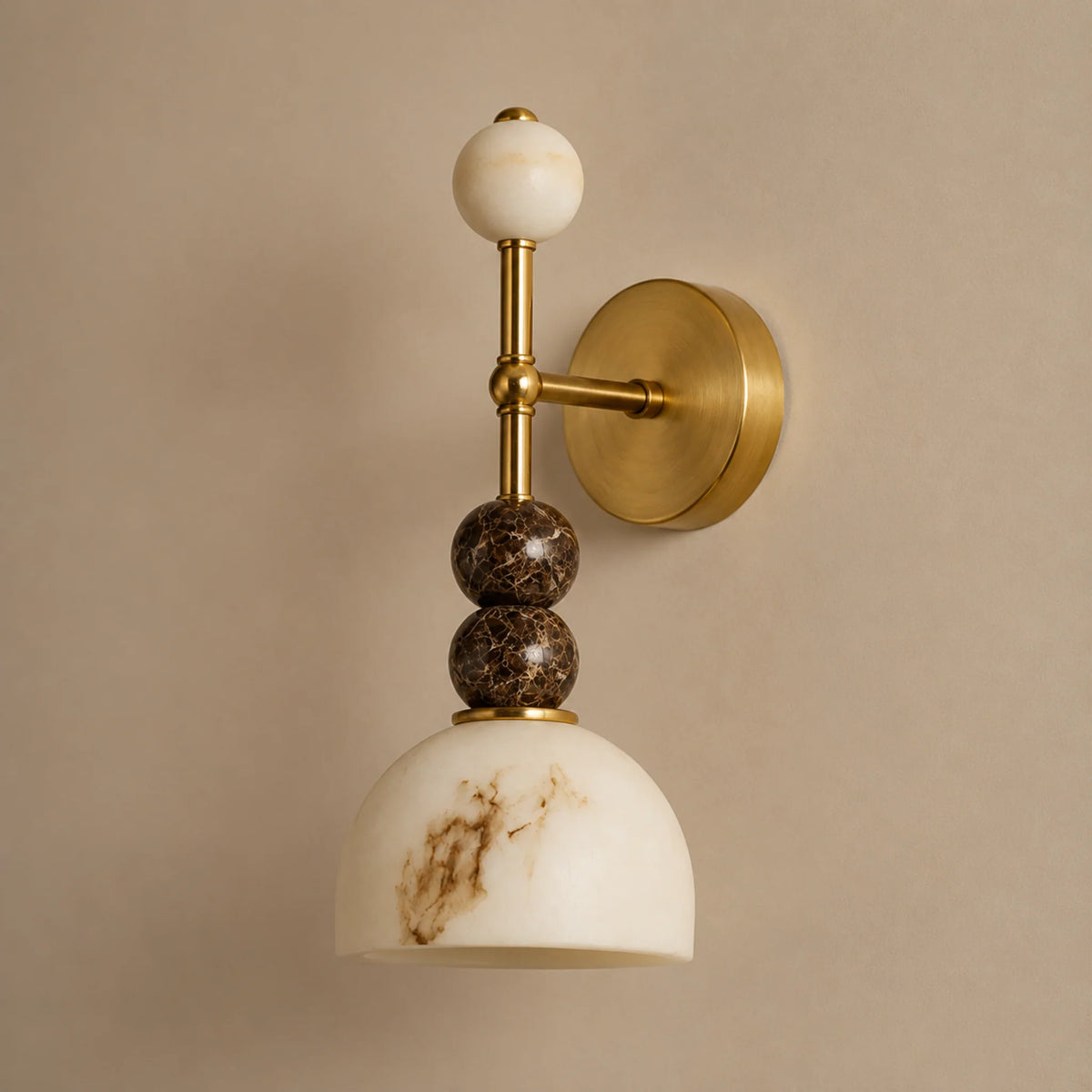 Mathilde marble wall light showing the marble beads and veined marble dome shade