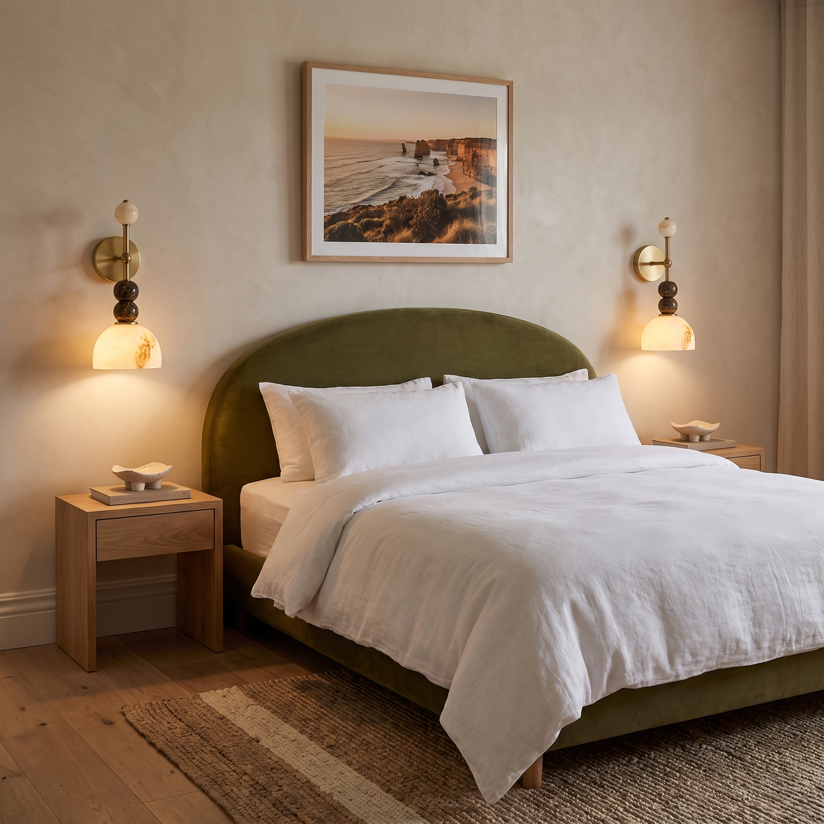Mathilde marble wall light either side of an olive velvet bedhead in a boutique hotel room