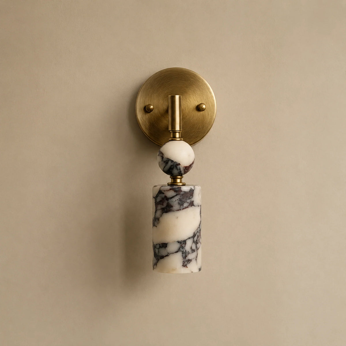 Matteo marble wall light showing the purple-black veined marble shade and brass wall plate