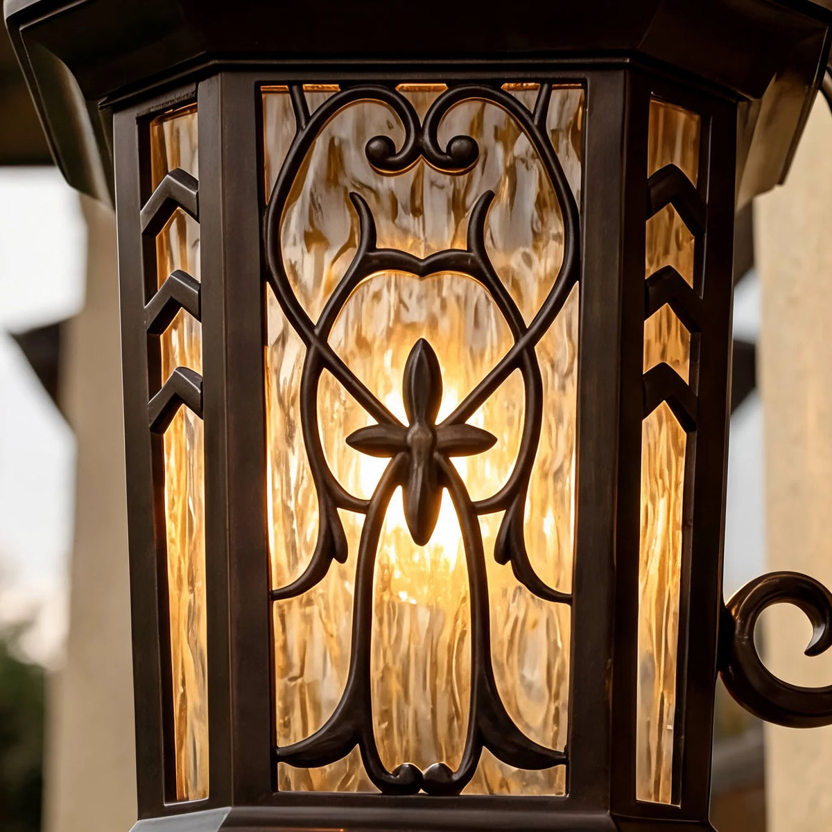 Close-up of the Meadows vintage wall lantern rippled glass panel with bronze scrollwork overlay lit warm