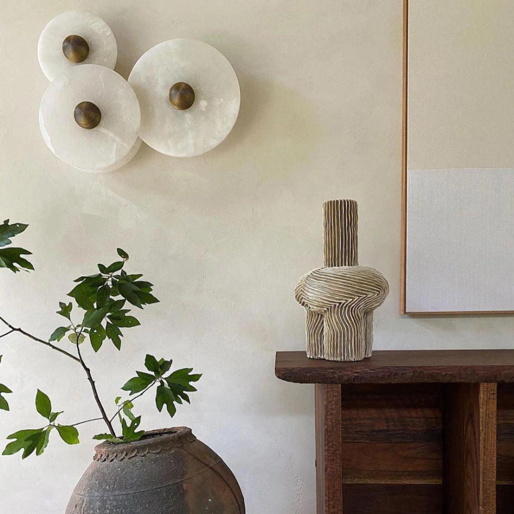 Detail of the concealed aluminium frame behind the Miki round alabaster wall light