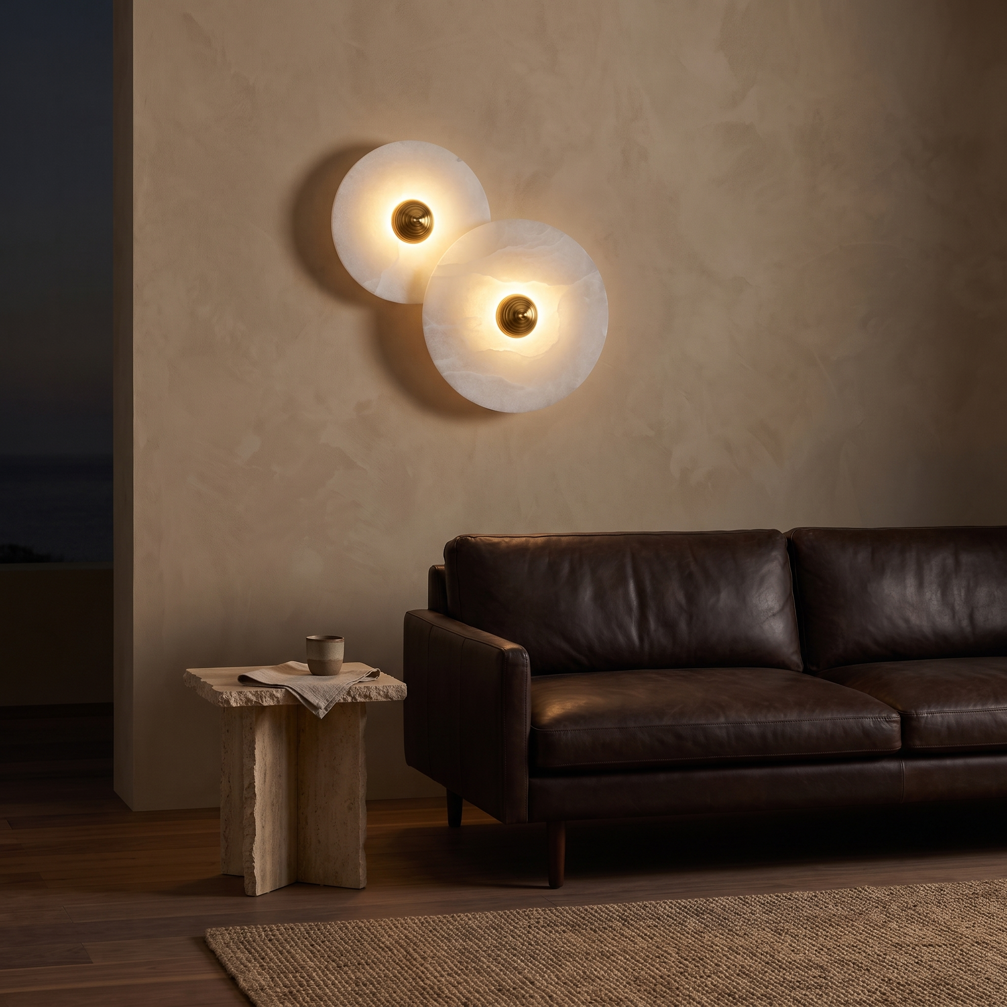 Miki round alabaster wall light two-disc set on a polished plaster wall above a leather sofa