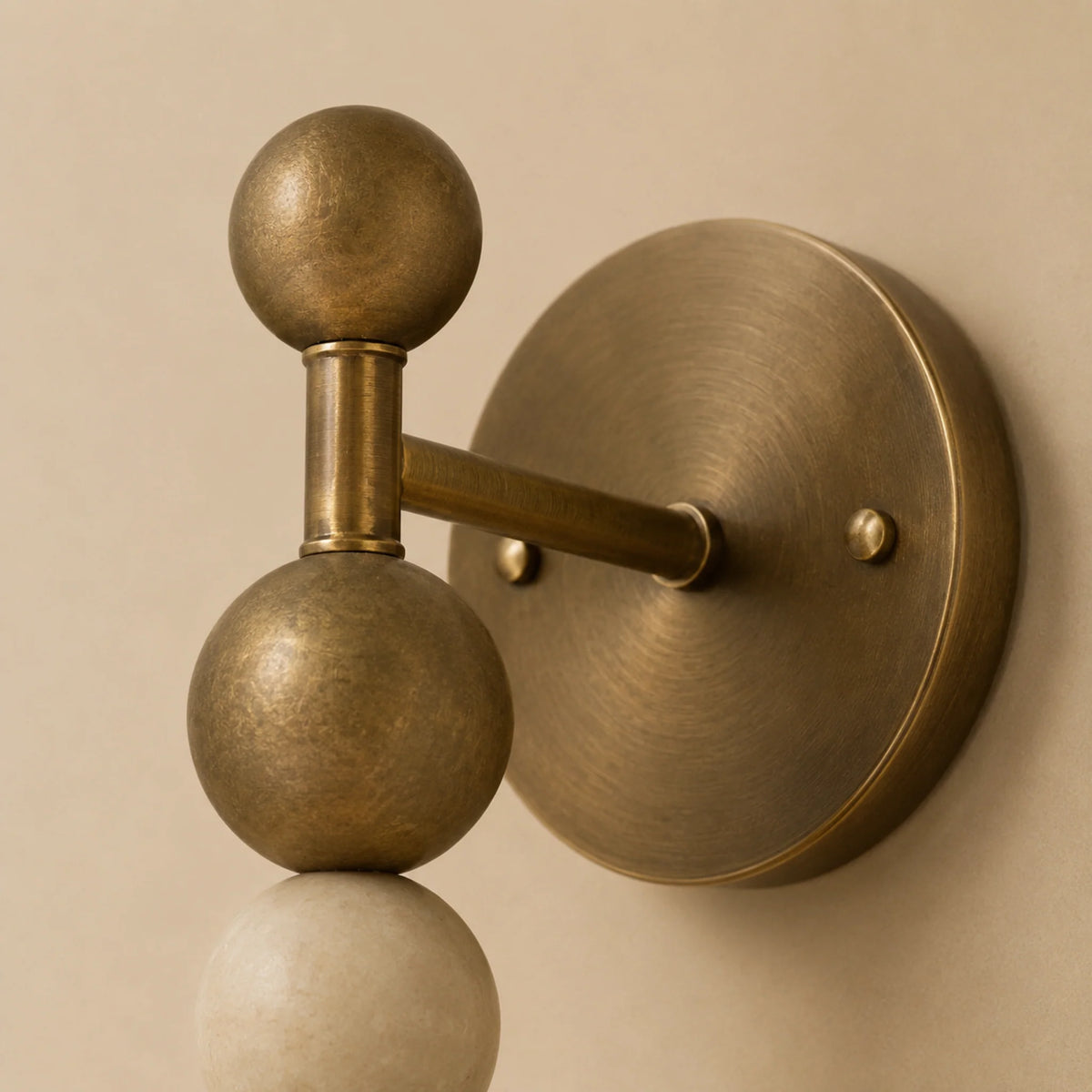 Monti marble bead wall light close up of the vintage brass balls and round wall plate