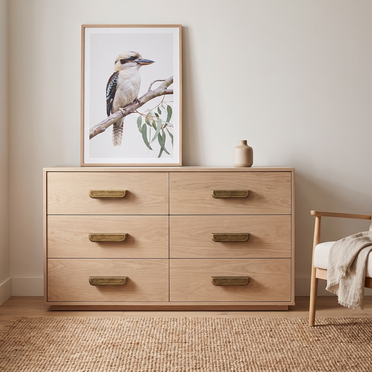Murko antique bronze cabinet handles in medium on a white oak six-drawer chest in a bedroom