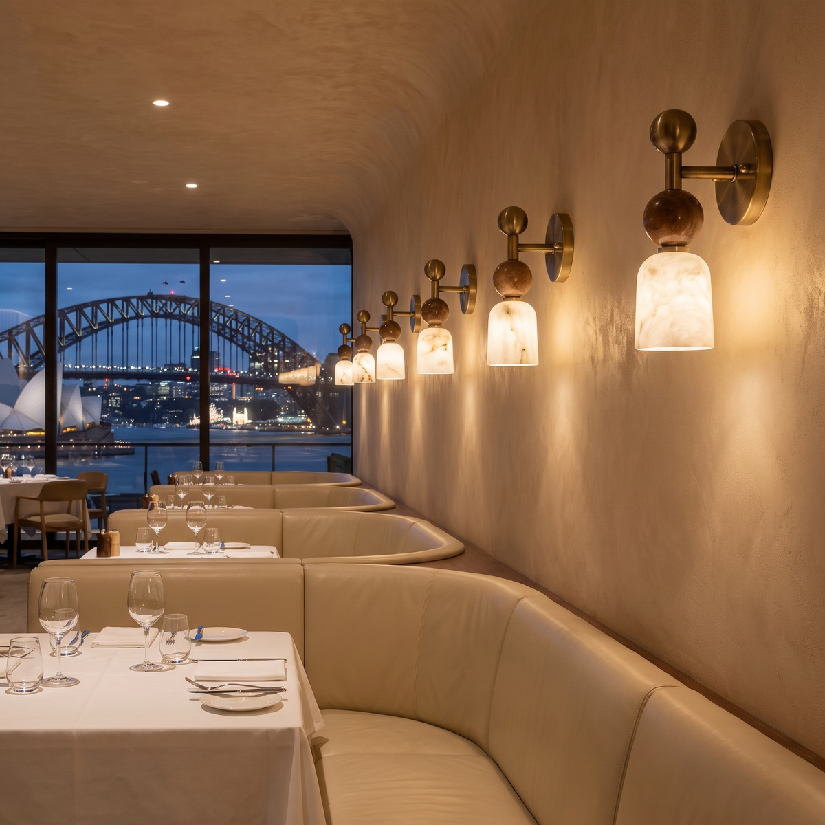 Nalu alabaster wall light along a restaurant wall overlooking Sydney Harbour