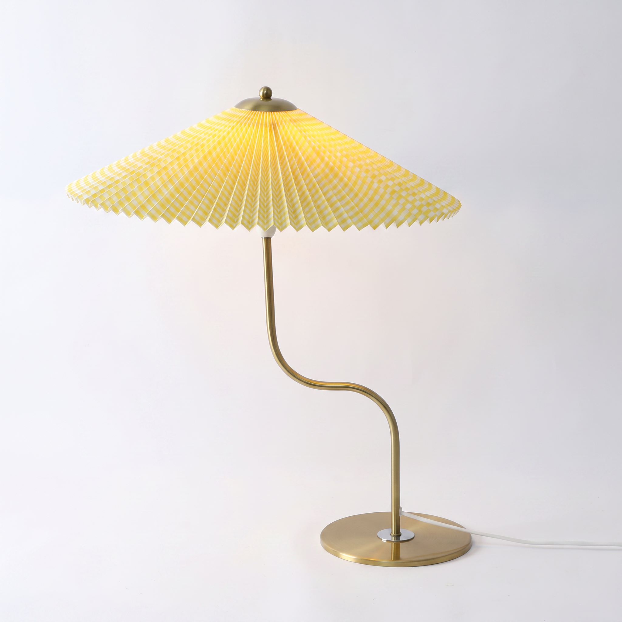 Newton retro checkered brass table lamp in yellow on a white background