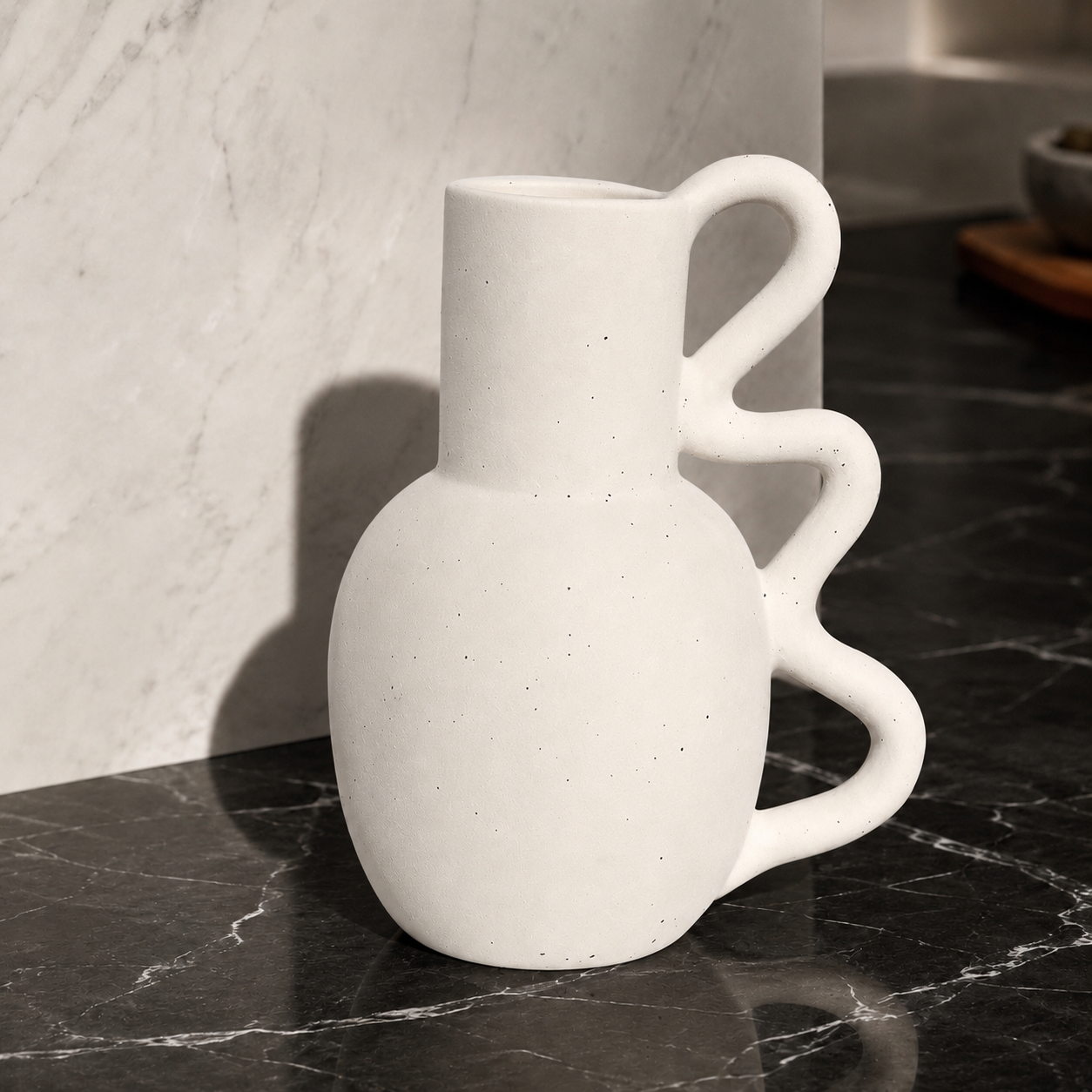 Nuru Ceramic Vase displayed on a shelf, showcasing its speckled finish
