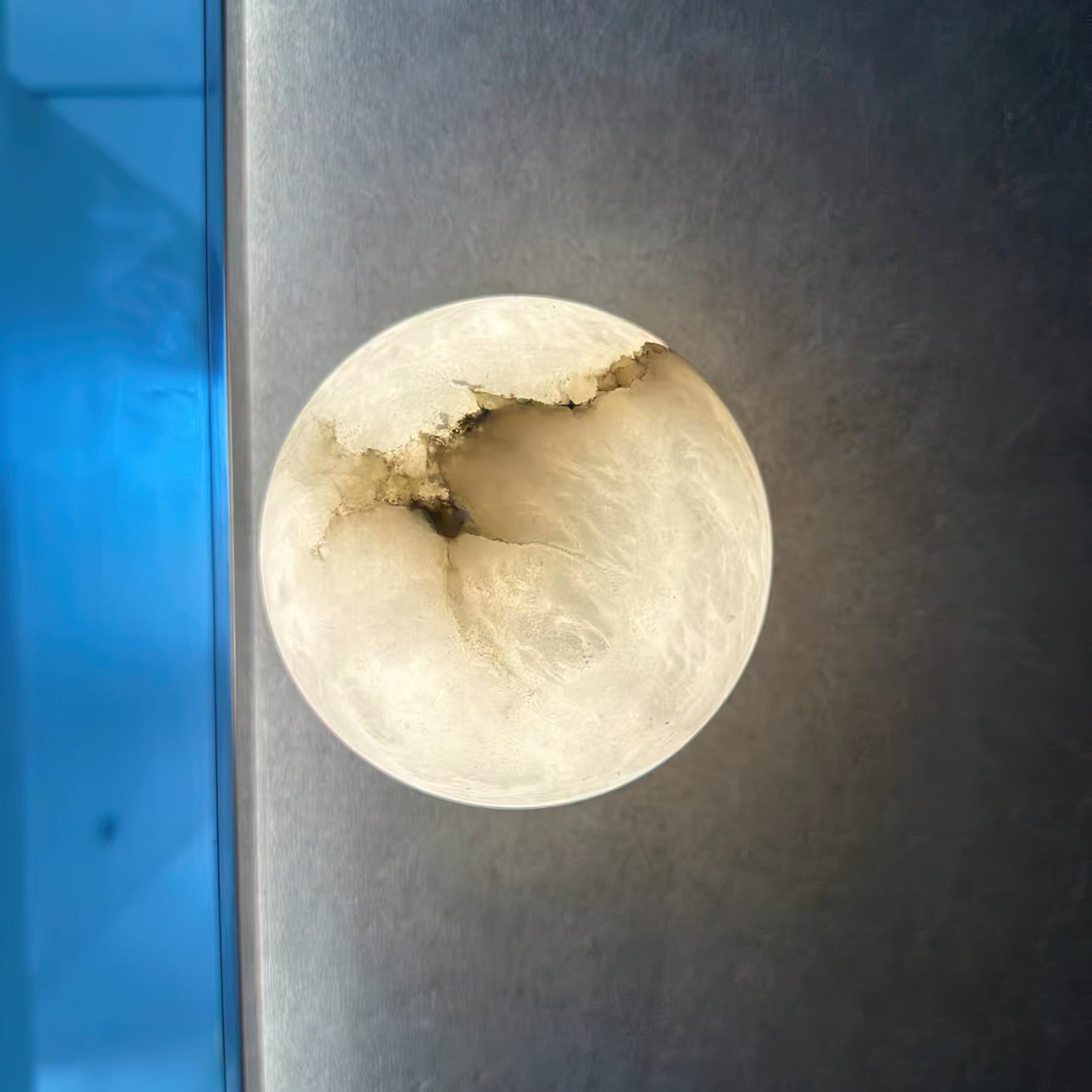 Orby alabaster wall lamp shown in both the 12cm and 15cm sizes