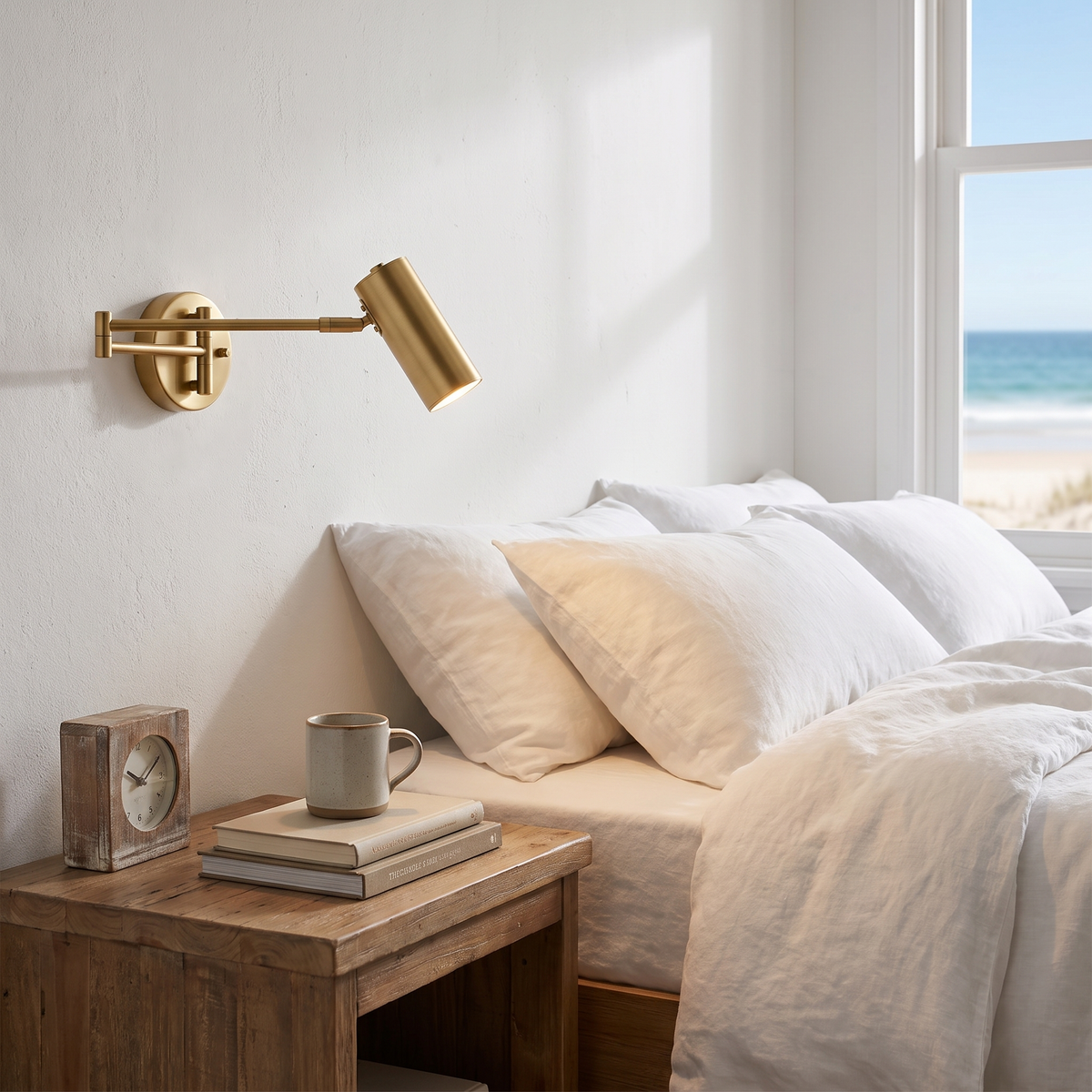 Oren swing arm wall spotlight in brass in a beach house bedroom