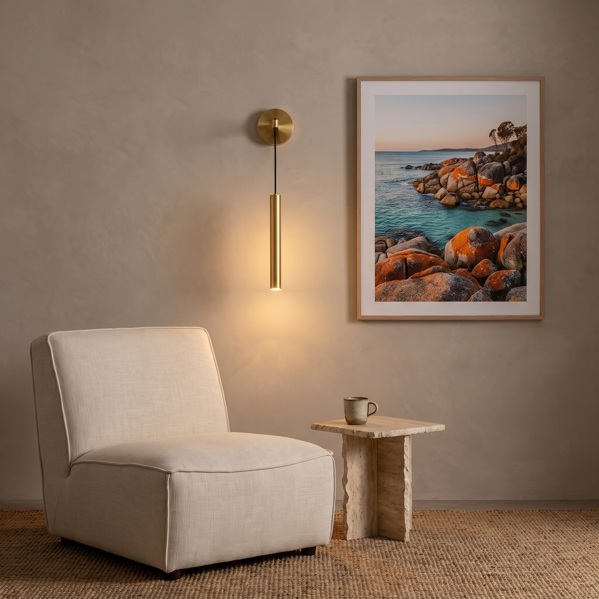 Sab brass suspended LED wall light beside a linen lounge chair