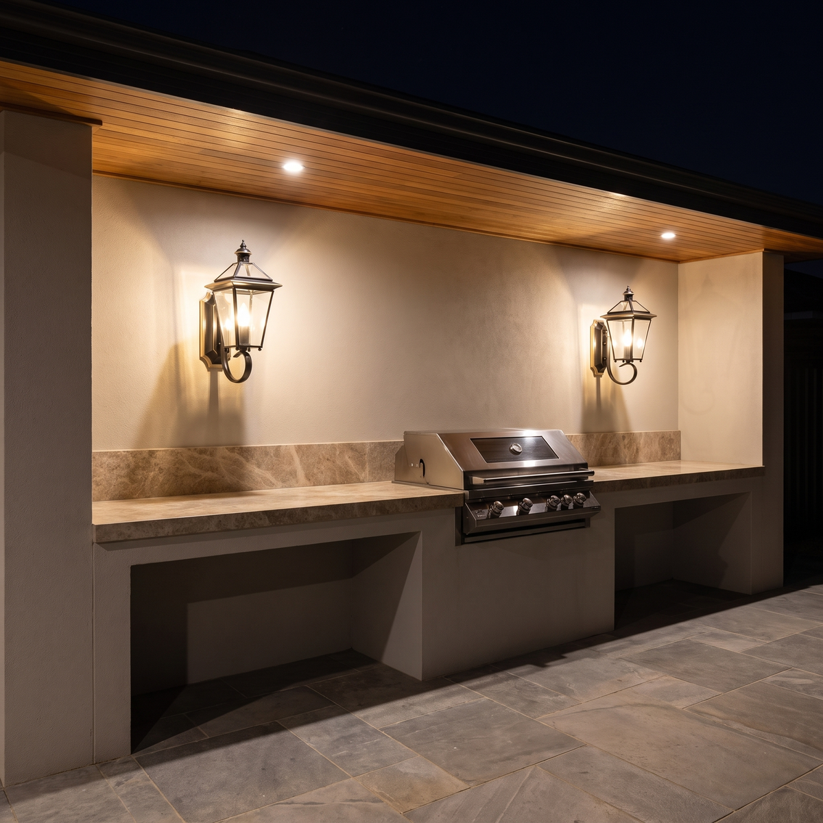 Black Sade outdoor lantern mounted on a brick garden wall beside planting at dusk