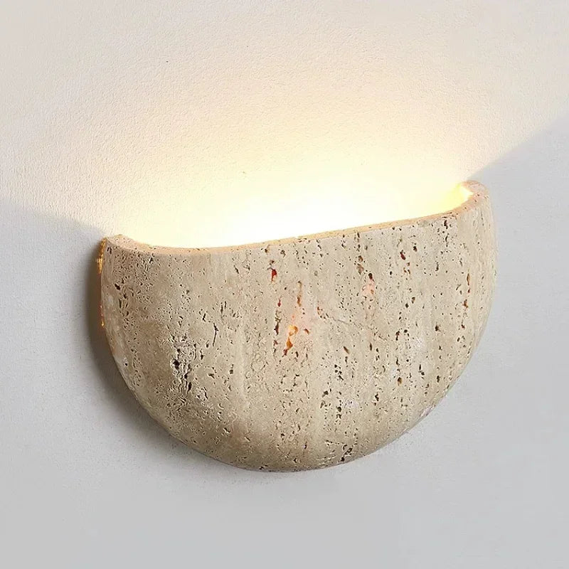 Sali travertine wall lamp mounted on a wall with soft ambient glow