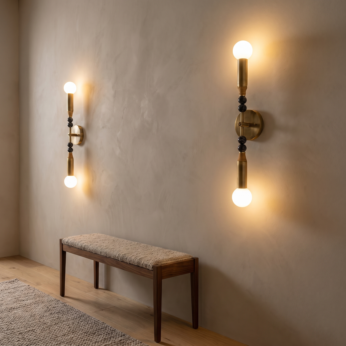 Double Sands brass and black marble wall sconces with up and down globes in a hallway