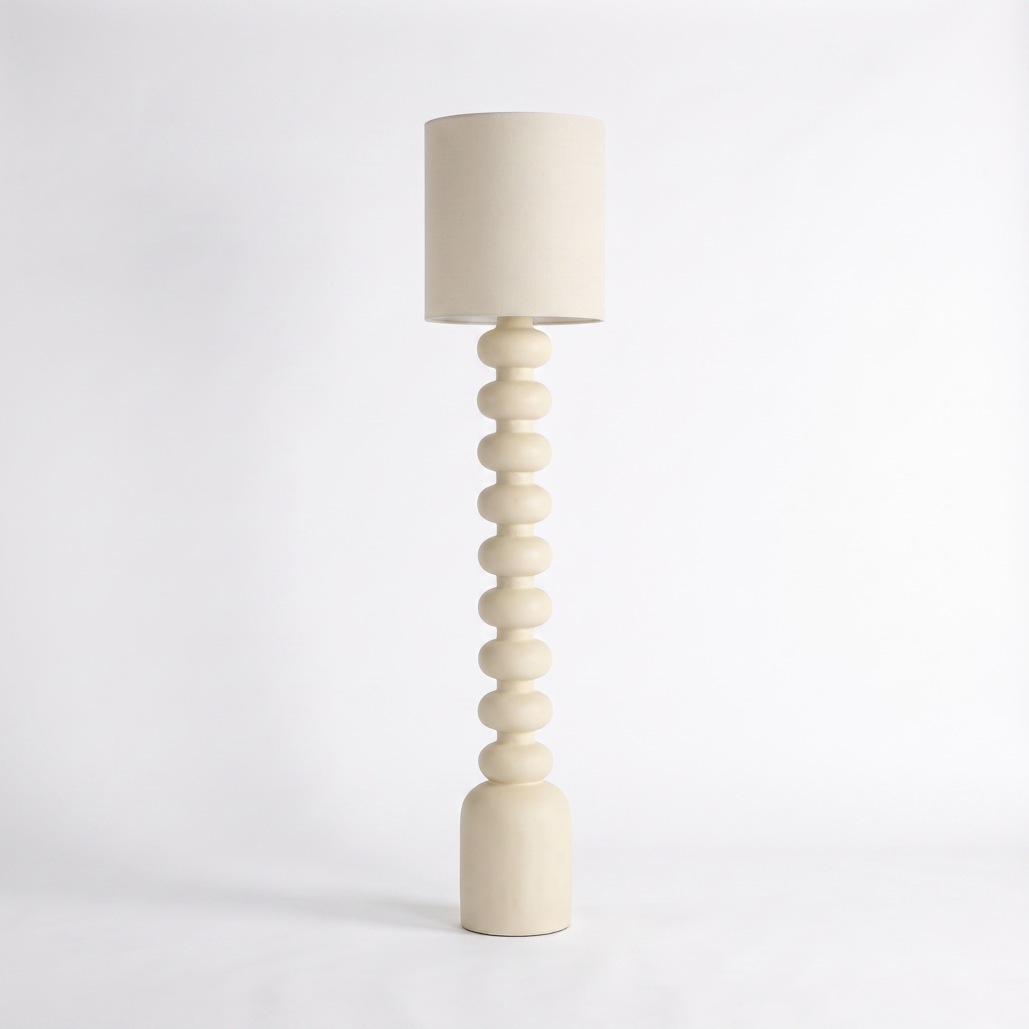 Sorrento resin and fabric floor lamp in beige on a white background