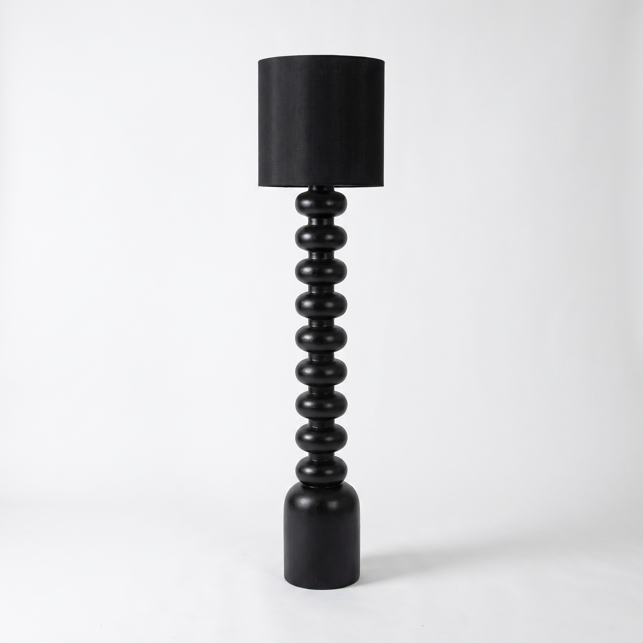 Sorrento resin and fabric floor lamp in black on a white background