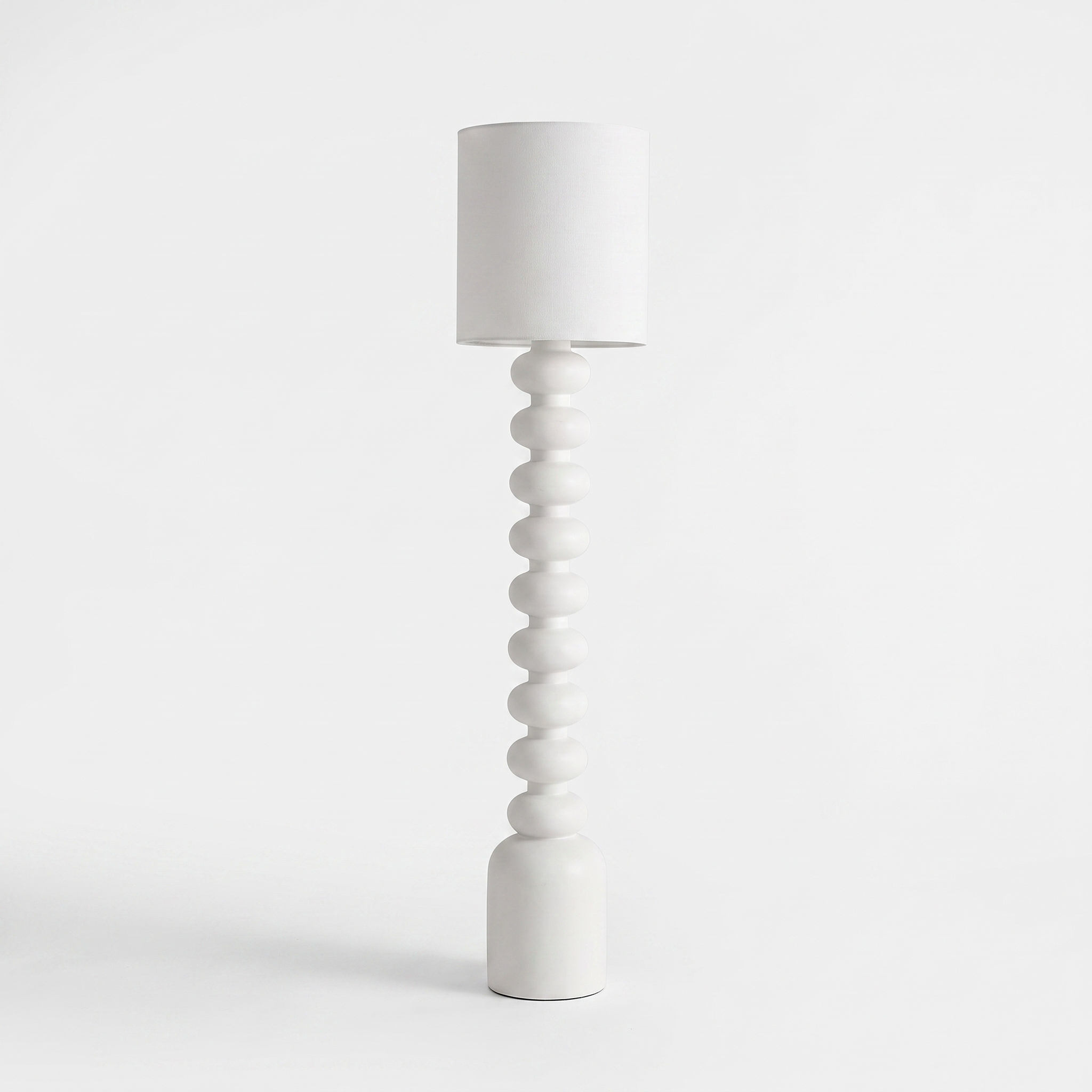 Sorrento resin and fabric floor lamp in white on a white background
