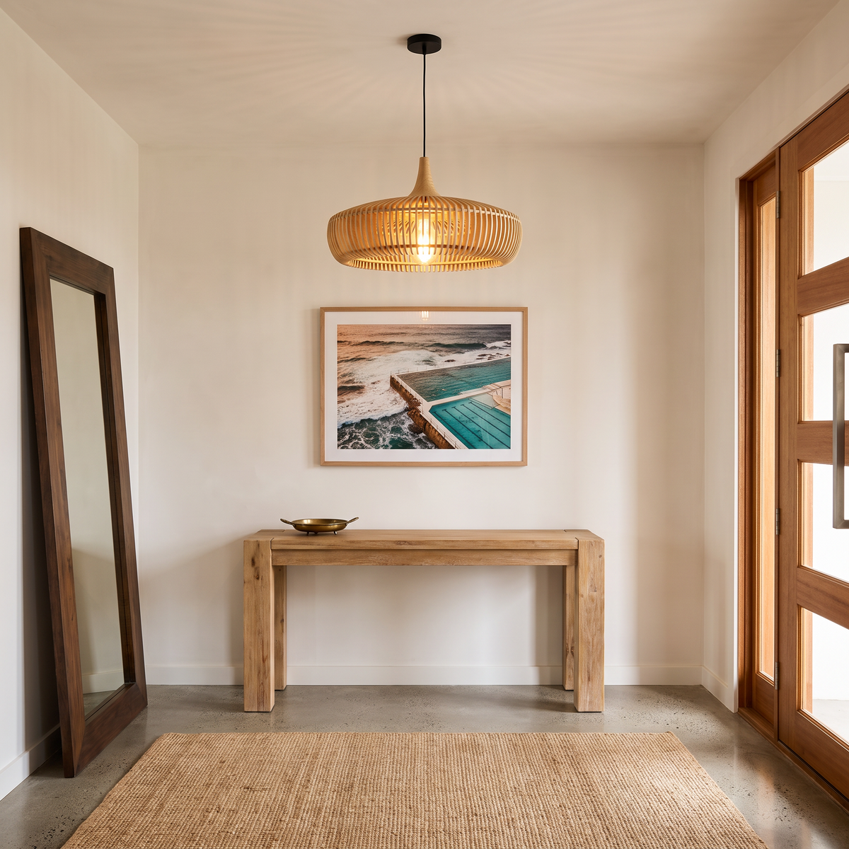 Natural wood Talandji Scandinavian pendant light above an oak console in an entry hall