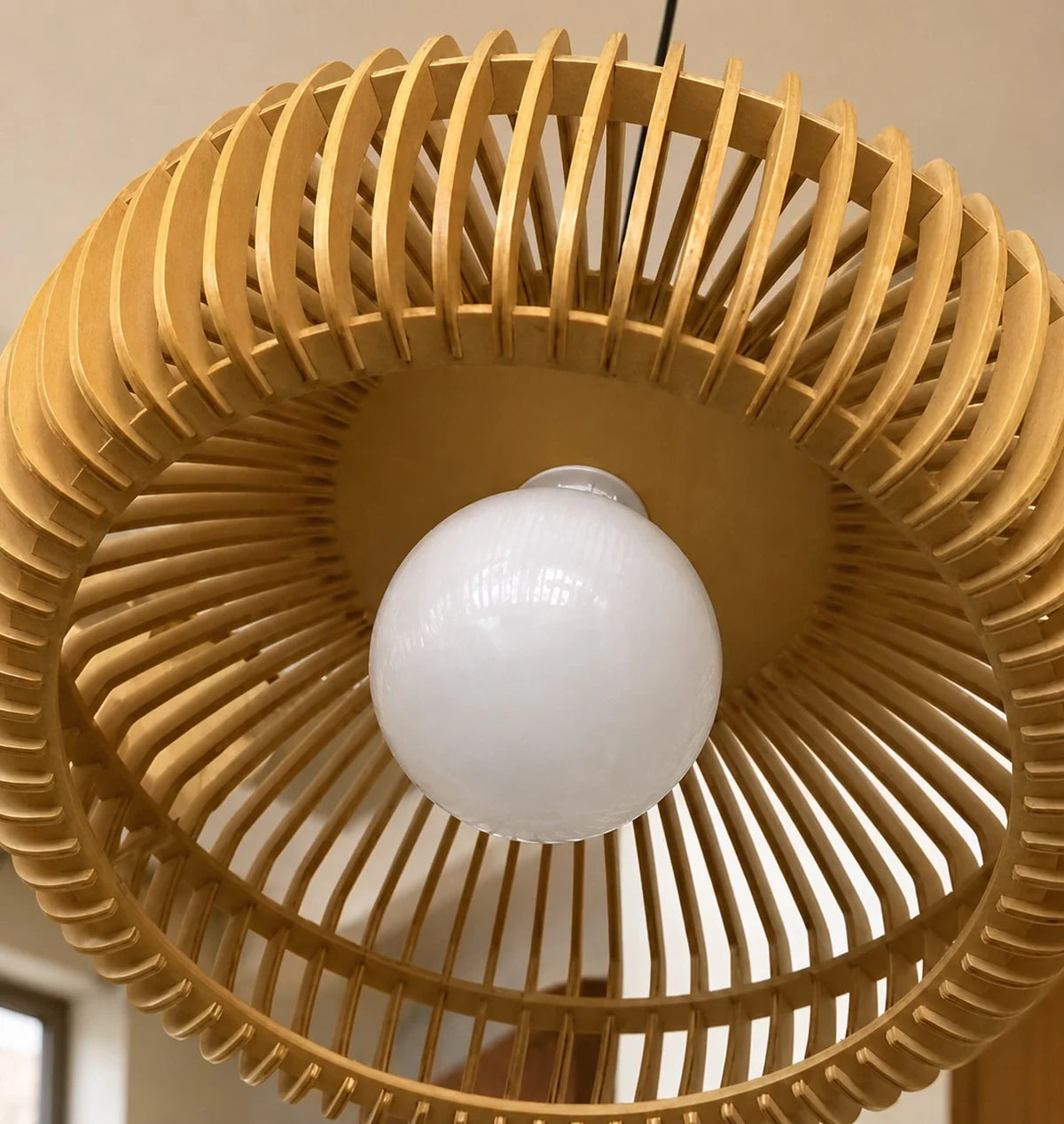 Underside view of the Talandji timber slats with the bulb glowing inside