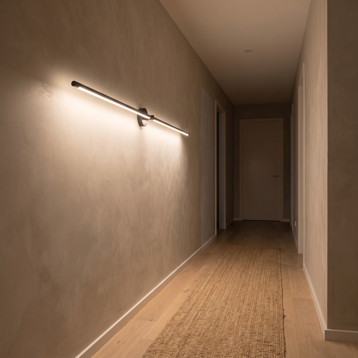 Close view of the black Tomi linear wall sconce casting even warm light