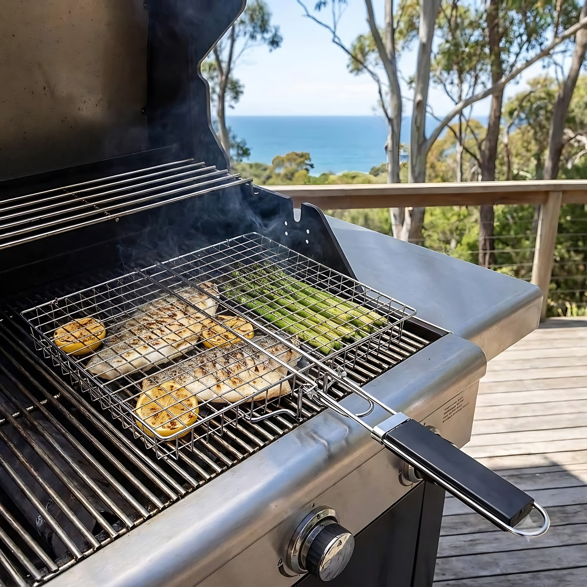Toni deep grilling basket with barramundi and asparagus on a gas BBQ on a deck with ocean views