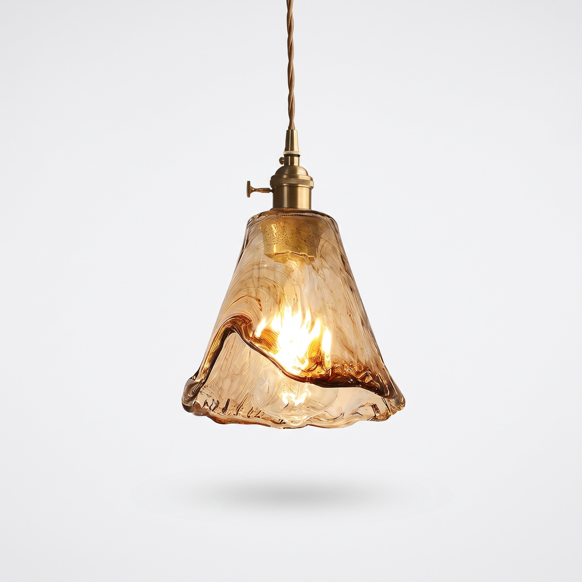 Tooky Model A flared amber glass pendant with brass lamp holder on a plain white background