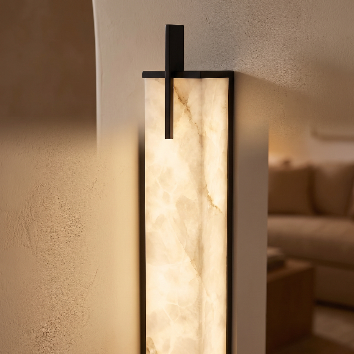 Close-up of the Tyla alabaster panel glowing with its black metal end bar