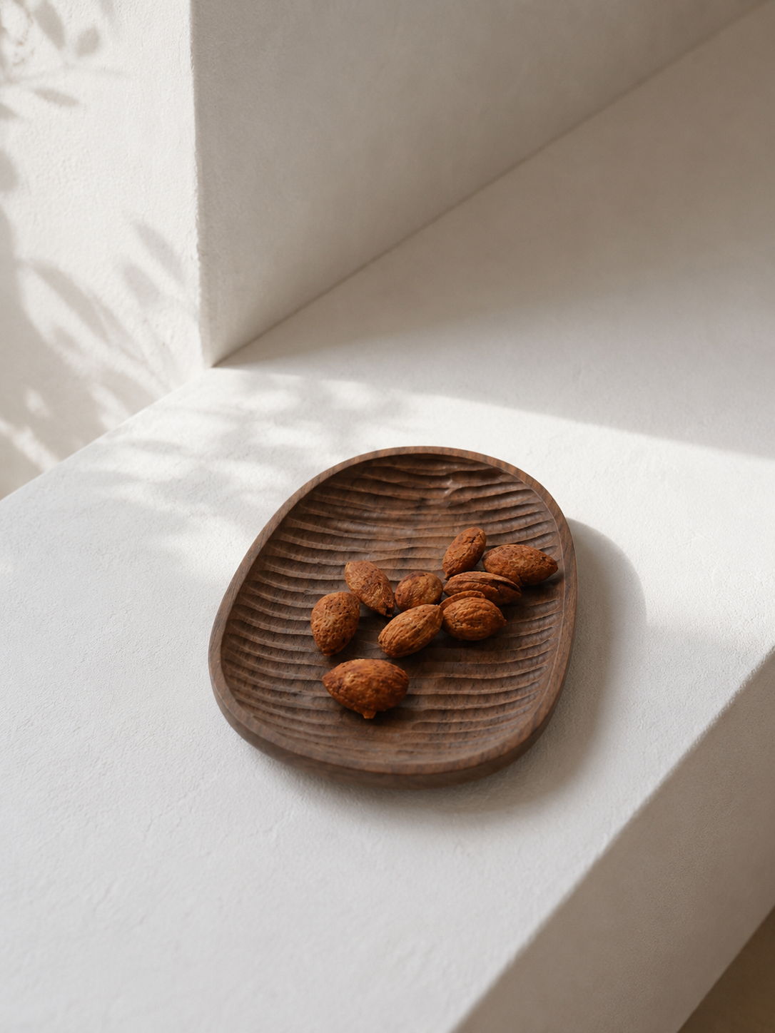 Ubud Walnut Wood Serving Plate on a dining table