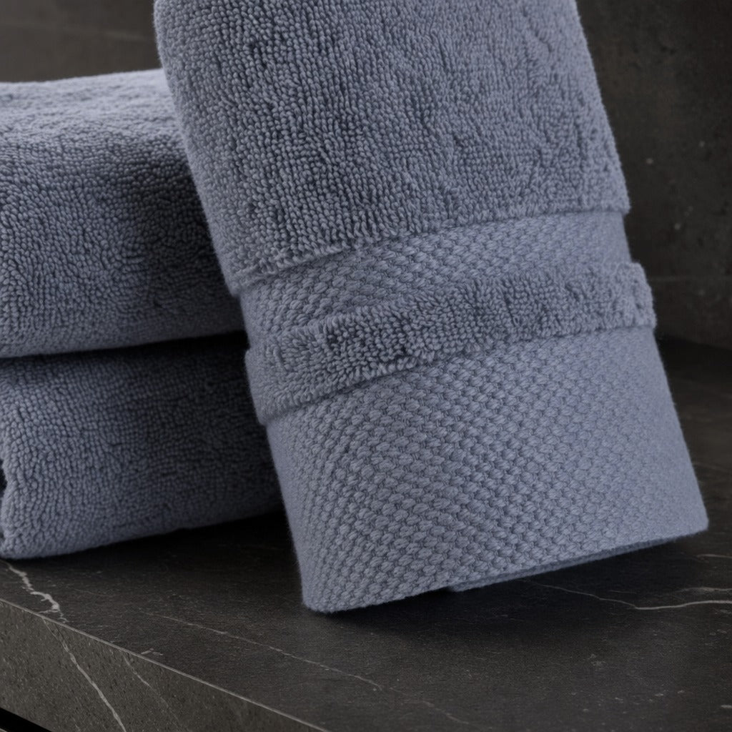 Close-up of a velour striped cotton blend bath towel showing its soft pile and woven border