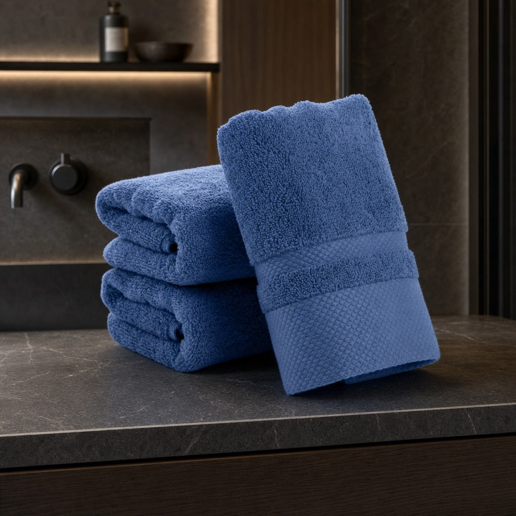 Velour striped cotton blend bath towels in dark blue on a dark stone vanity in a moody bathroom
