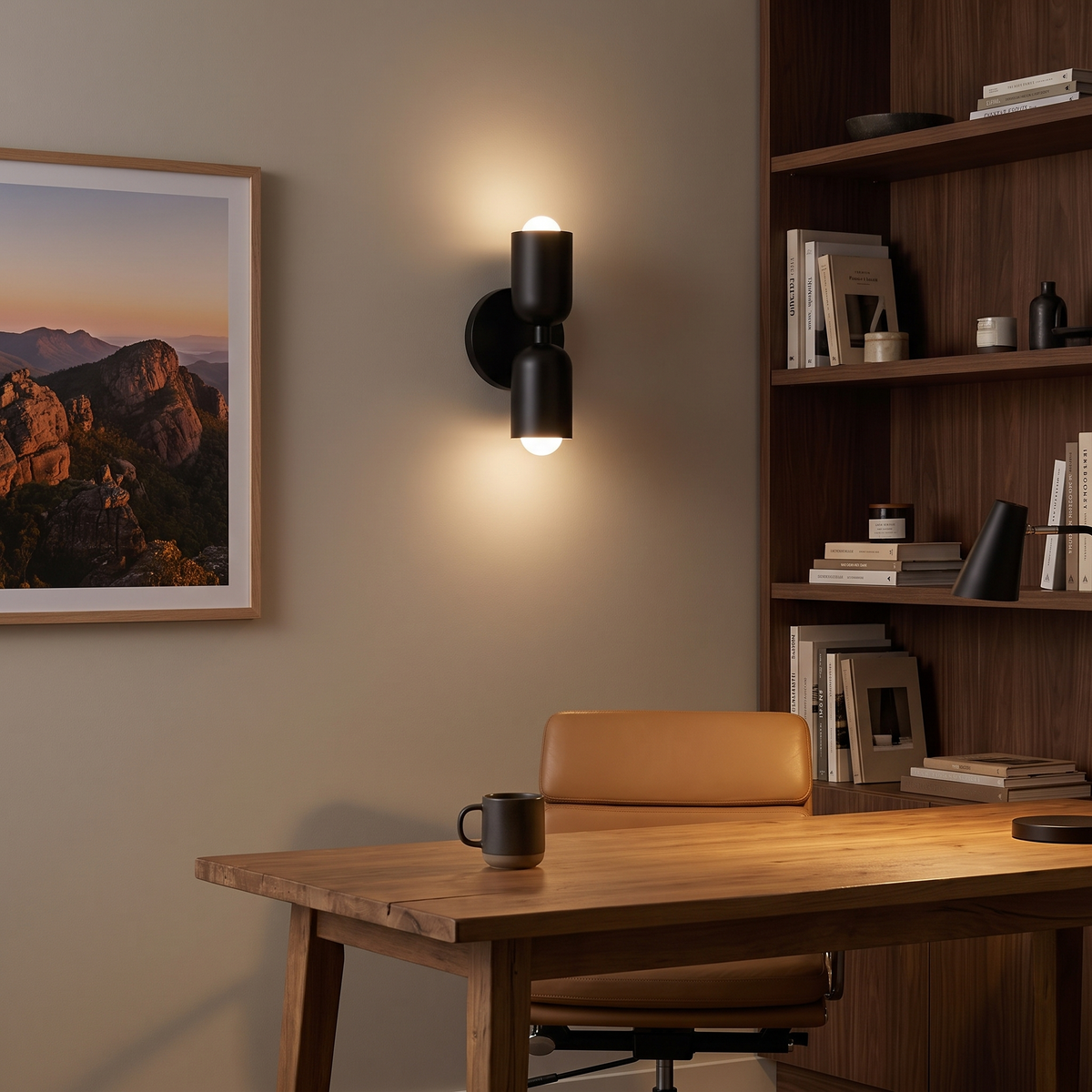 Vic all-black up down wall sconce above a timber desk in a home office