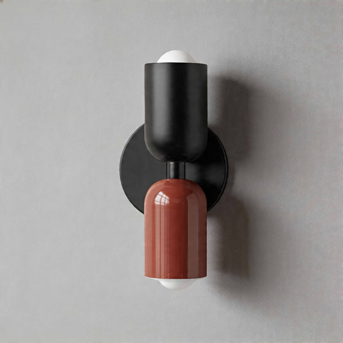 Vic Nordic up down wall sconce with a black wall plate, black upper shade and red lower shade