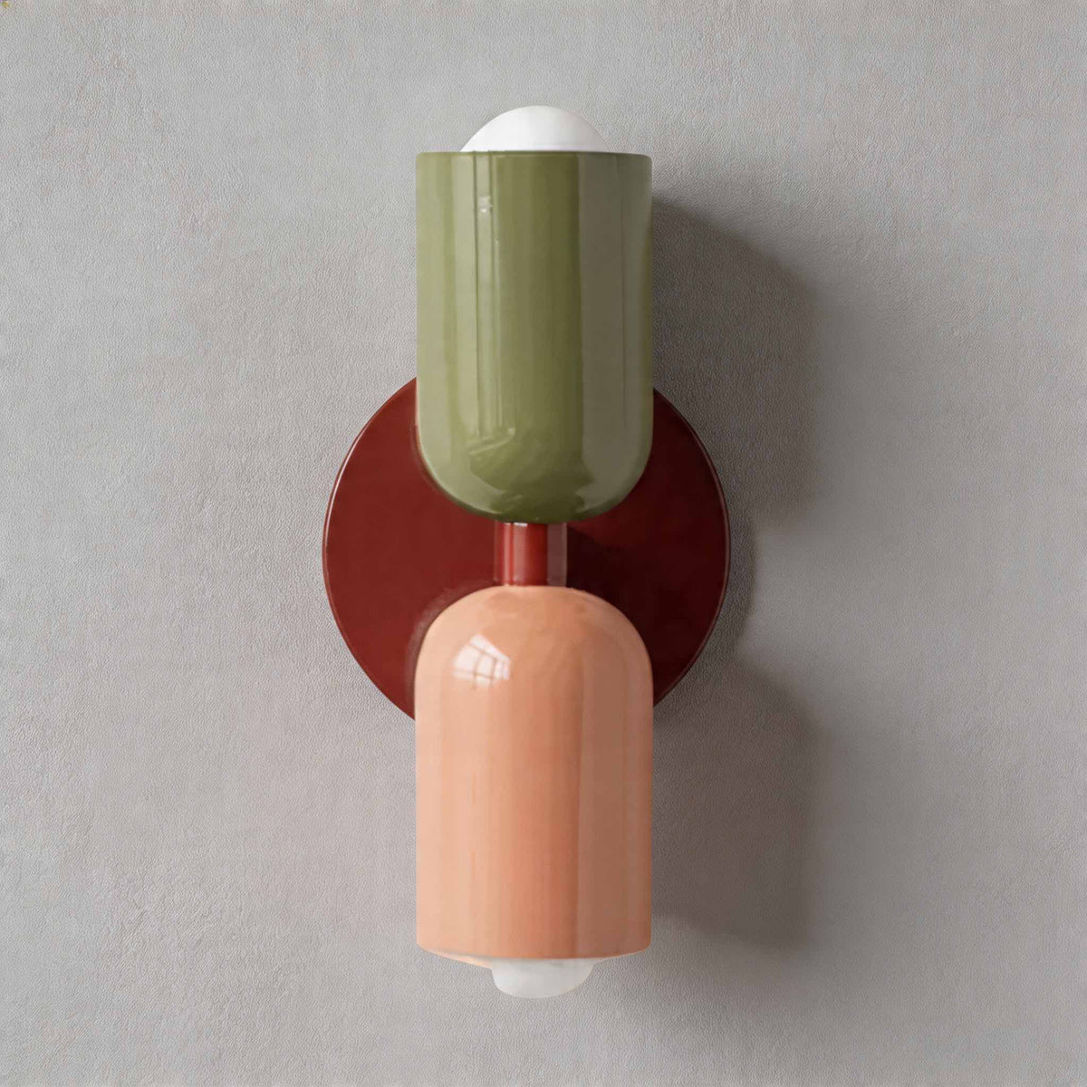 Vic Nordic up down wall sconce with a red wall plate, green upper shade and pink lower shade