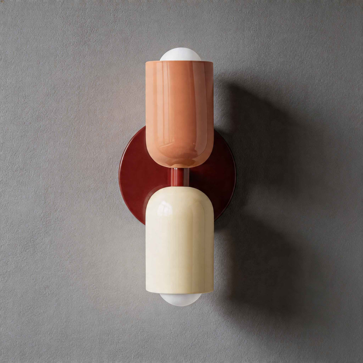 Vic Nordic up down wall sconce with a red wall plate, pink upper shade and white lower shade
