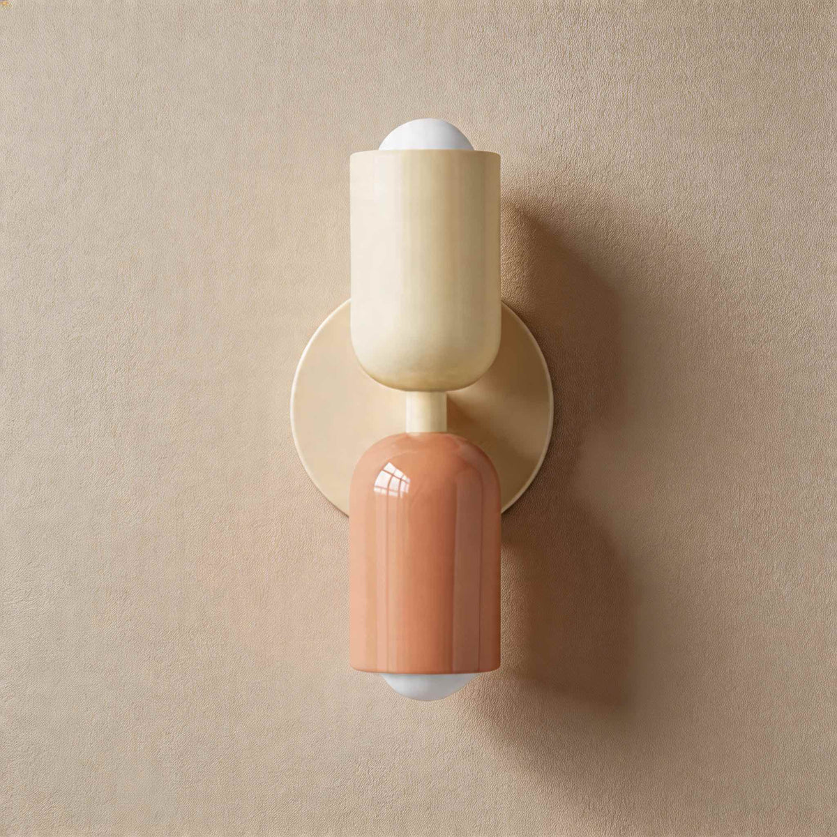 Vic Nordic up down wall sconce with a white wall plate, white upper shade and pink lower shade