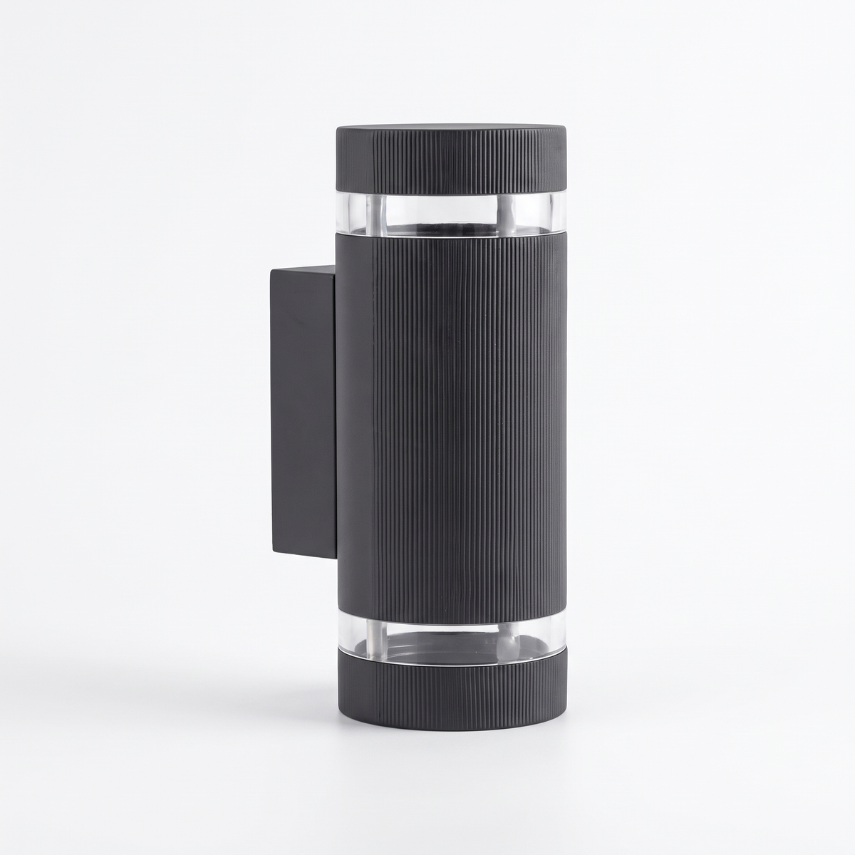 Visage up down wall light, a black ribbed aluminium outdoor cylinder sconce, on a white background