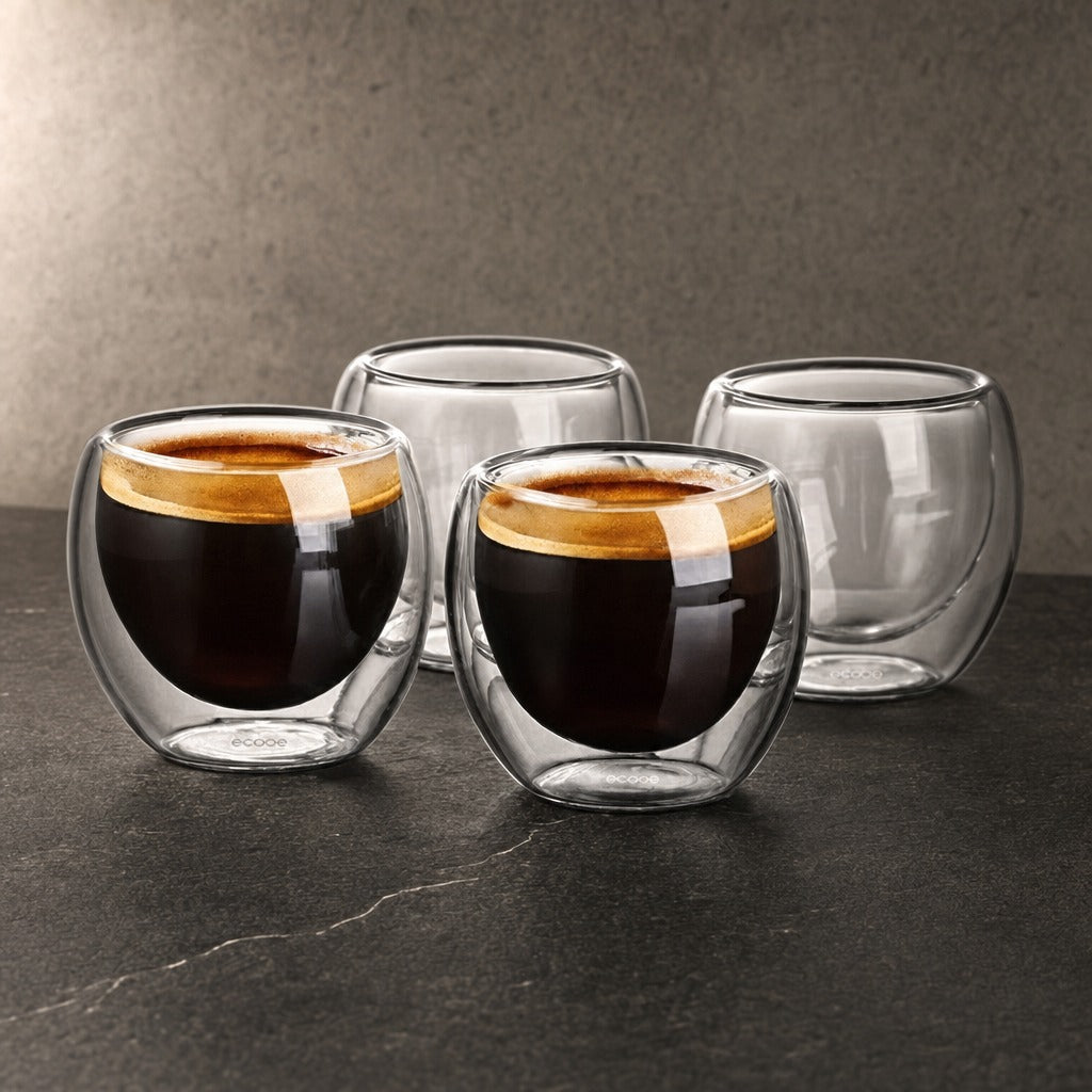 Zorin double-wall glass espresso cups with golden crema on a dark stone benchtop